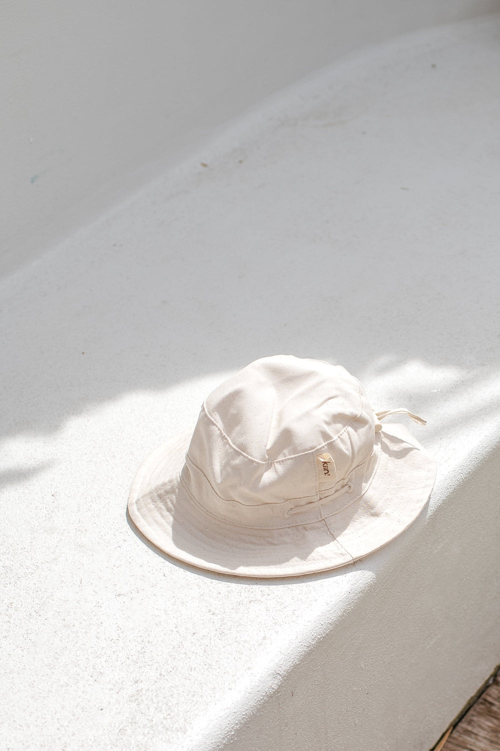 Kiin Oat cotton sun hat with its wide brim and adjustable back detail